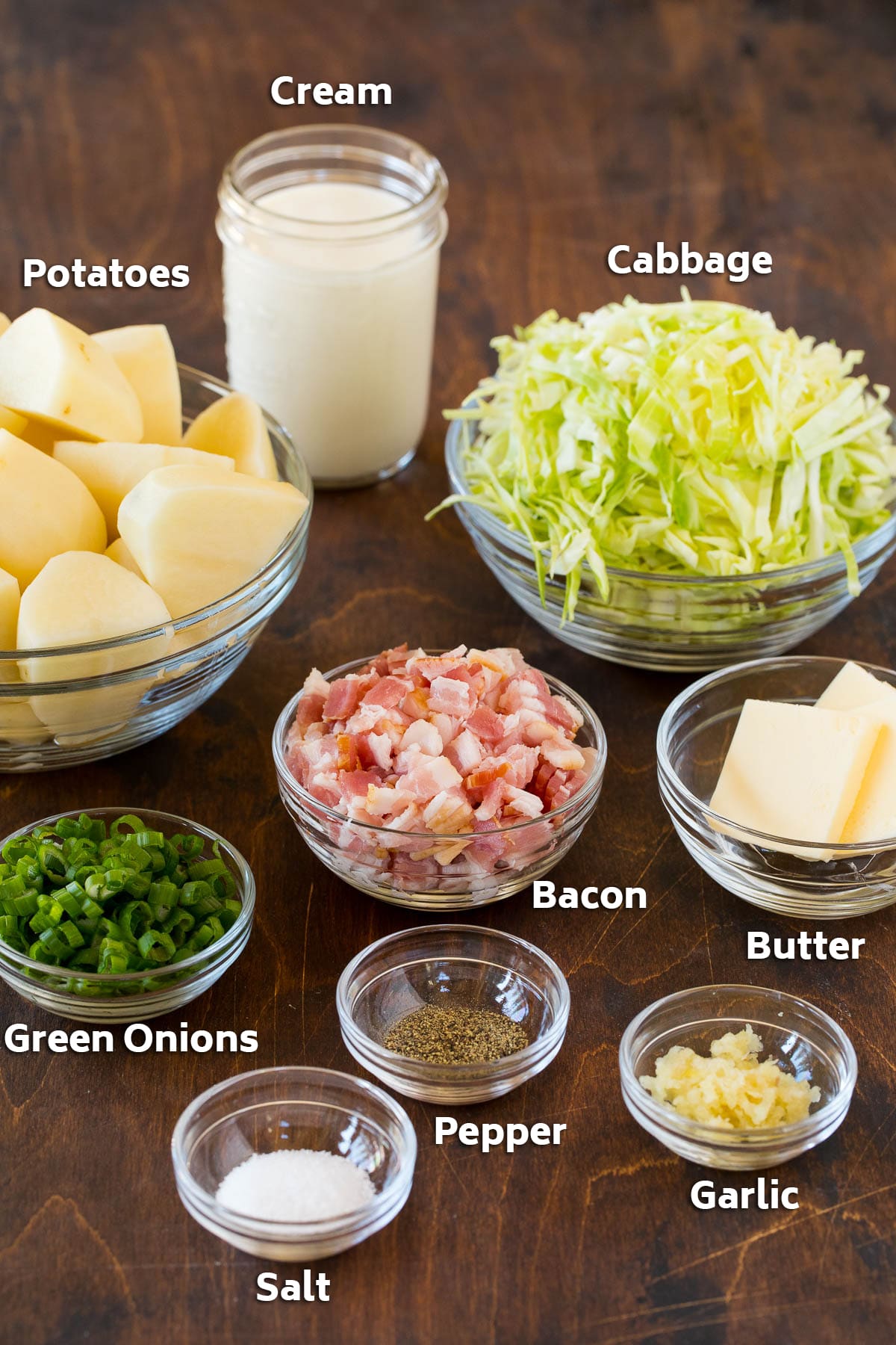 Colcannon Recipe | Mashed Potatoes #potatoes #cabbage #bacon #sidedish #stpatricksday #dinner #ezlod Bowls of bacon, cabbage, potatoes, and seasonings.