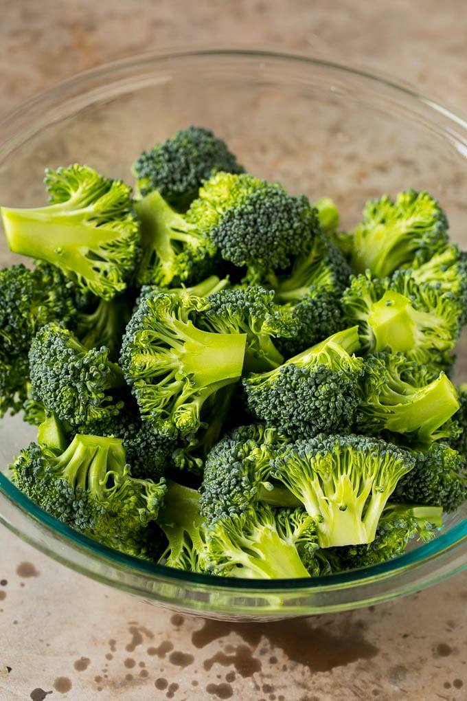 Grilled broccoli is packed with flavor and is a colorful and healthy side dish! #broccoli #ezlod Green florets in a bowl.