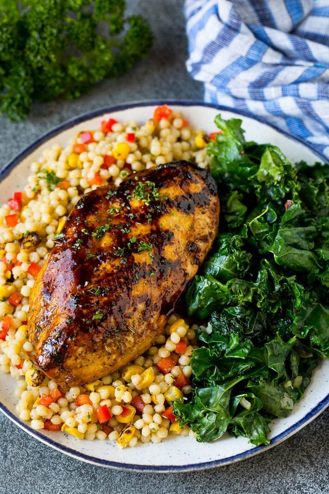 Sauteed kale flavored with olive oil and garlic, a quick and easy side dish! #kale #ezlod Grilled chicken served with a side of sauteed kale.