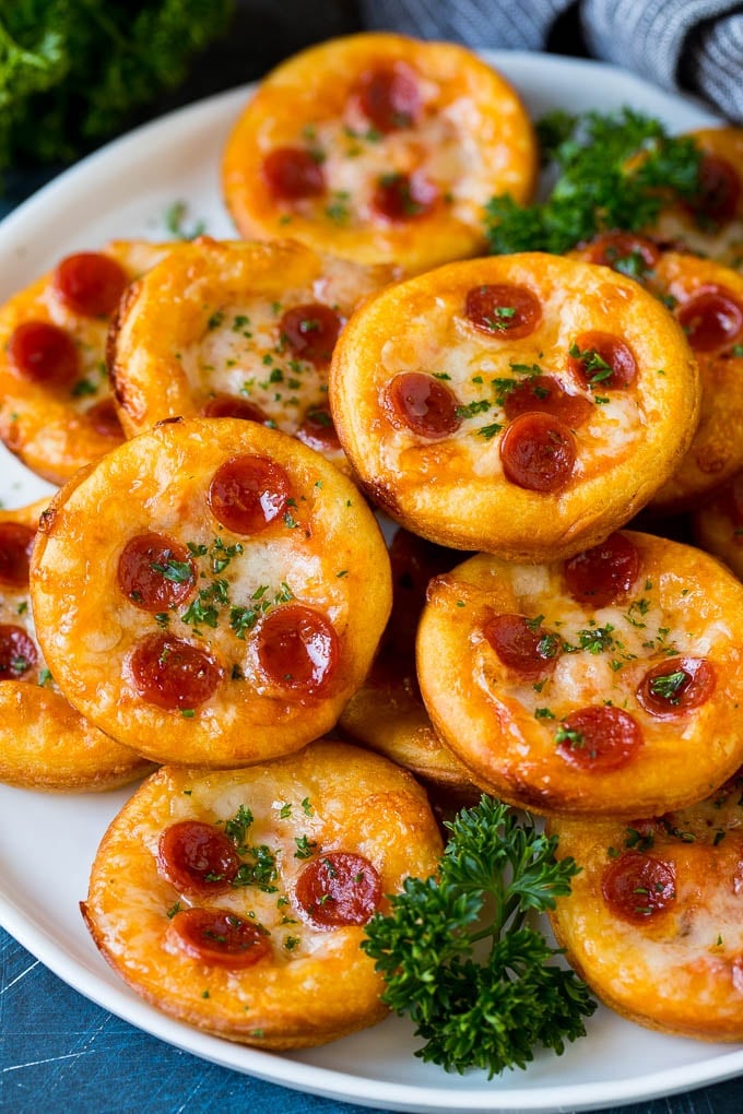Mini pizzas topped with pepperoni are a fun and easy appetizer option. #pizza #ezlod #appetizer Mini pizzas topped with melted cheese and pepperoni.