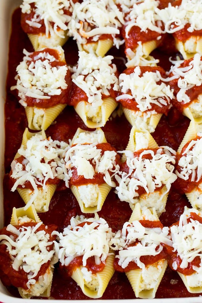 Baked stuffed shells filled with three types of cheese and topped with marinara sauce. #pasta #ezlod Filled pasta topped with marinara sauce and shredded cheese.