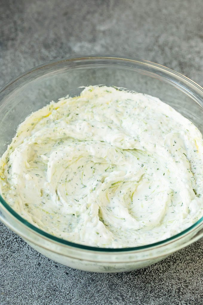 The best homemade tzatziki sauce with cucumber and herbs mixed into Greek yogurt. #appetizer #ezlod Tzatziki sauce in a glass bowl.