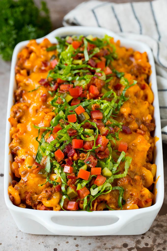 This cheeseburger casserole is ground beef, bacon, macaroni and plenty of cheese, all baked together to perfection. Cheeseburger casserole with ground beef and pasta, topped with melted cheese, bacon and tomatoes.