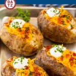 These oven baked potatoes are perfectly cooked with a crispy outside and fluffy inside.