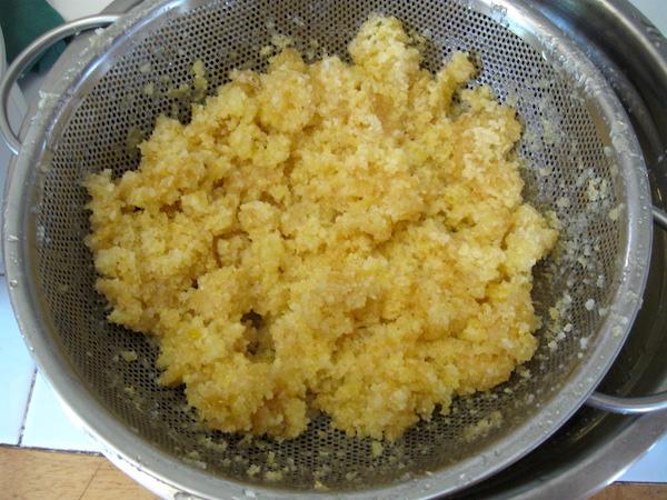 Strained Chunk honey comb during they honey extraction process as the liquid honey is drained through a colander 