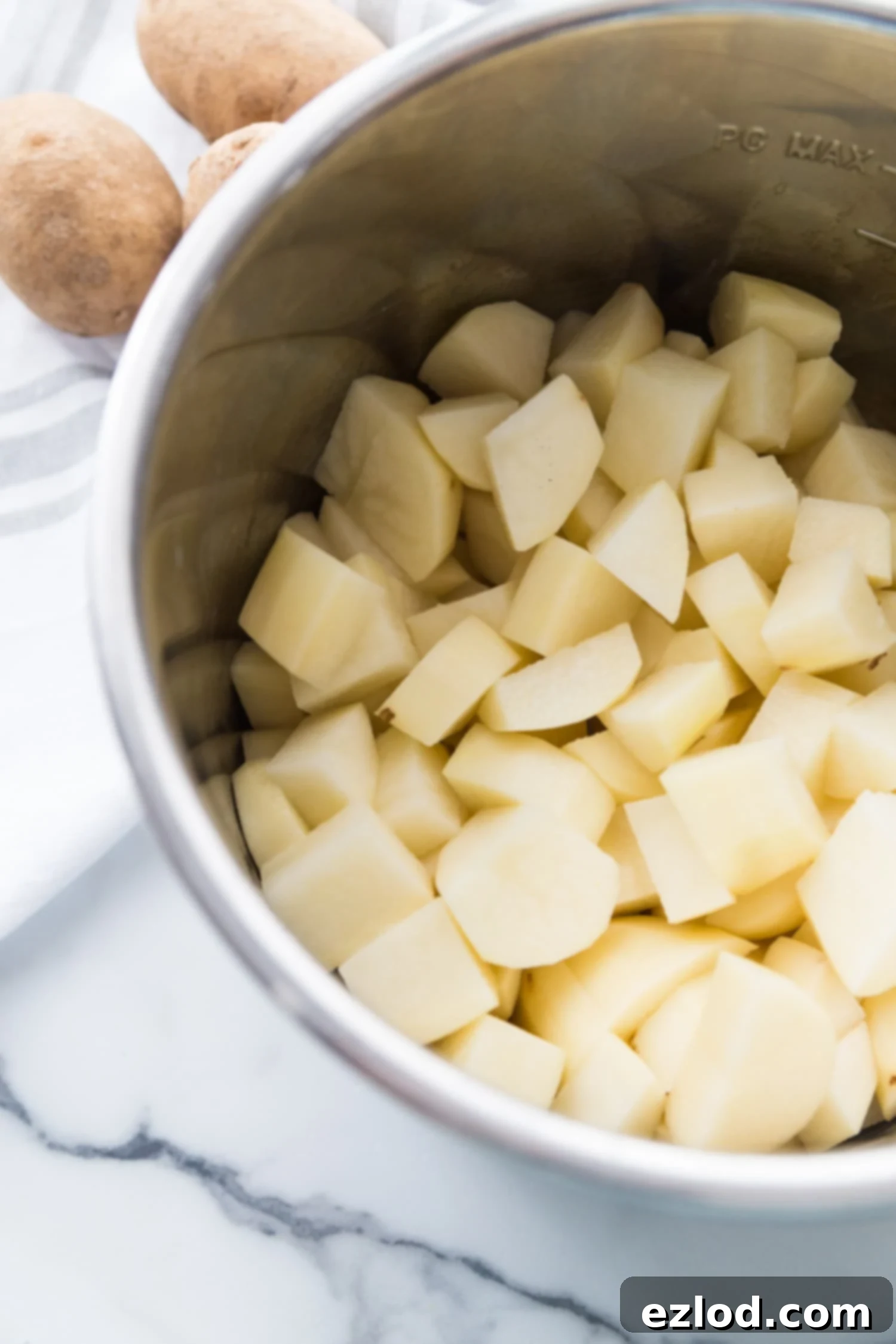 Diced russet potatoes inside of an Instant Pot inner lining.