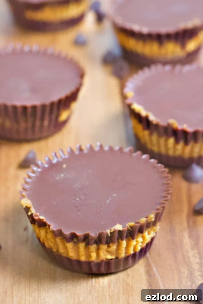 Homemade pumpkin chocolate chip cups on a wooden table, emphasizing the healthy and satisfying nature of the 21 Day Fix treat.