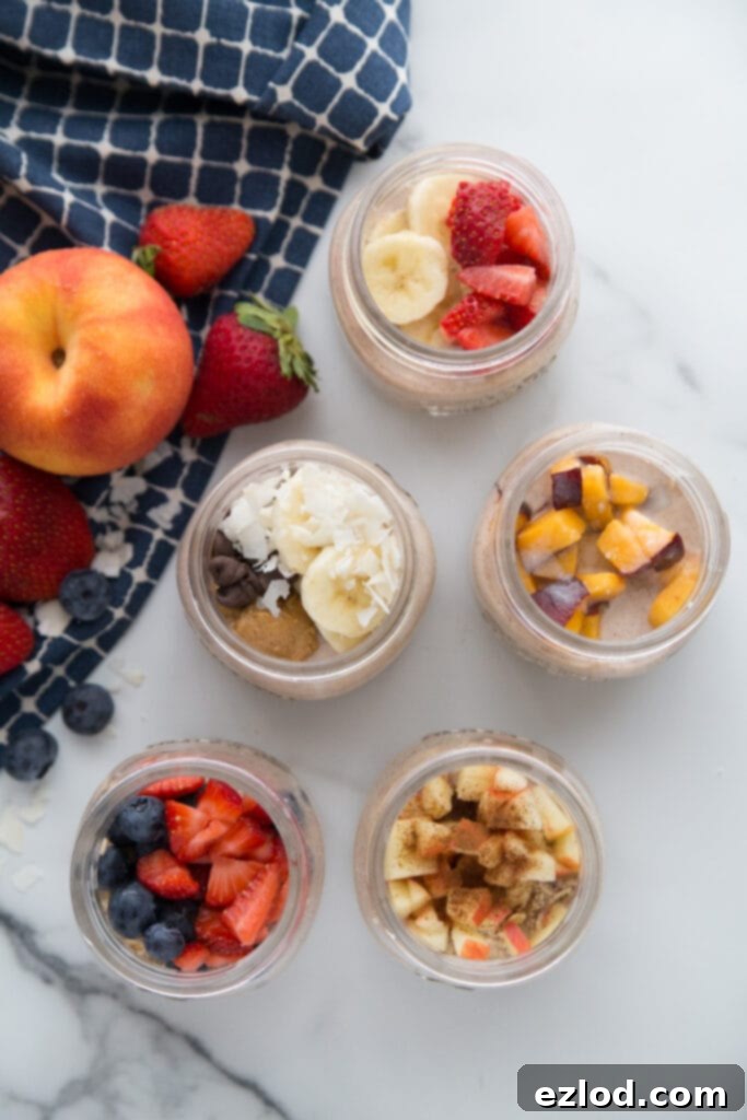A glass jar filled with layers of oats, berries, and yogurt, ready for a healthy breakfast.