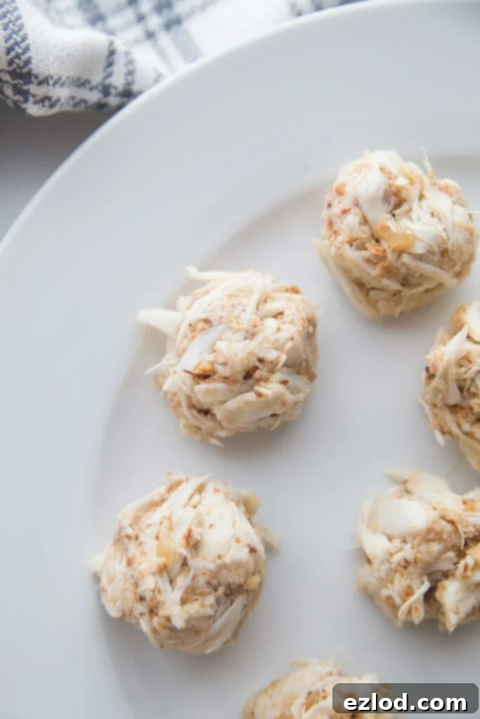 Mini crab cake appetizers on a white plate 