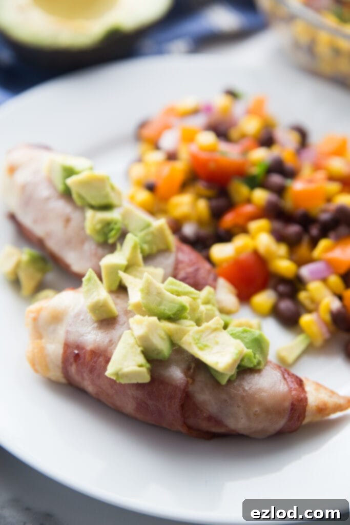 Crispy bacon-wrapped chicken tenders on a plate.
