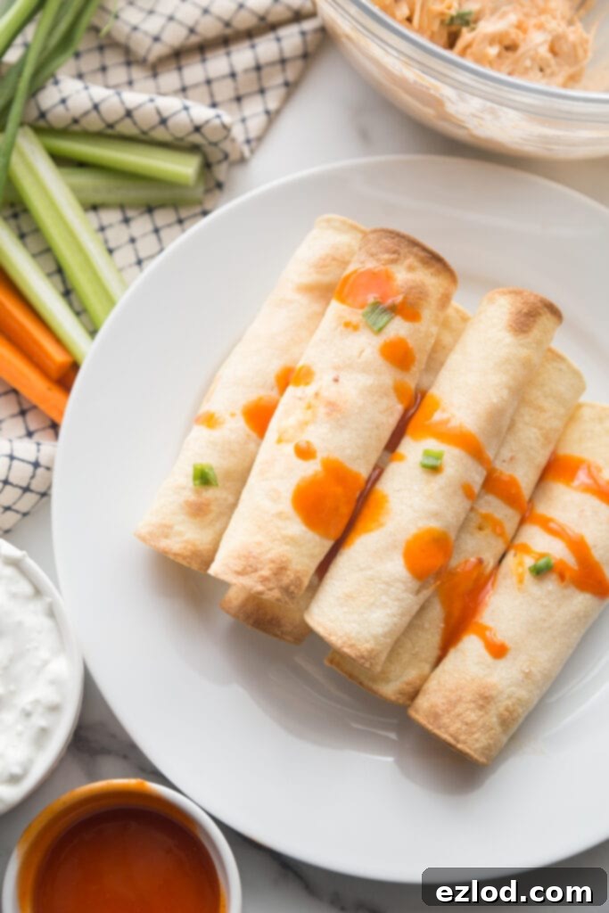 Crispy buffalo chicken taquitos served with ranch dressing and celery sticks.