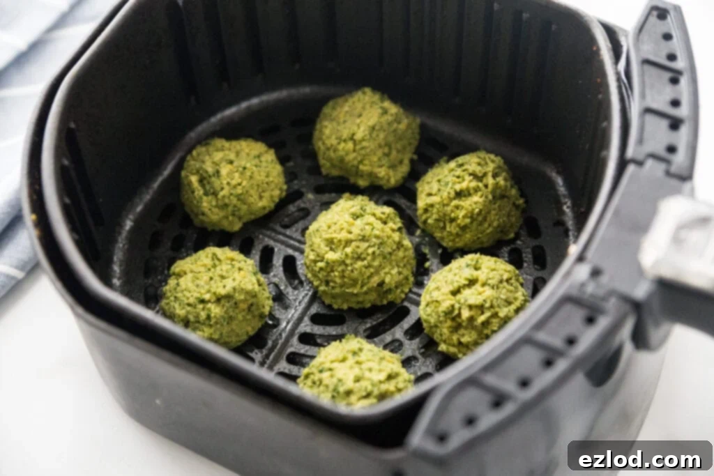 Air Fryer Basket full of Easy Falafel Bites ready to be cooked