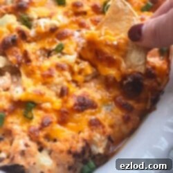 A smaller image of the Buffalo Cauliflower Dip, topped with browned cheese in a white oval dish.