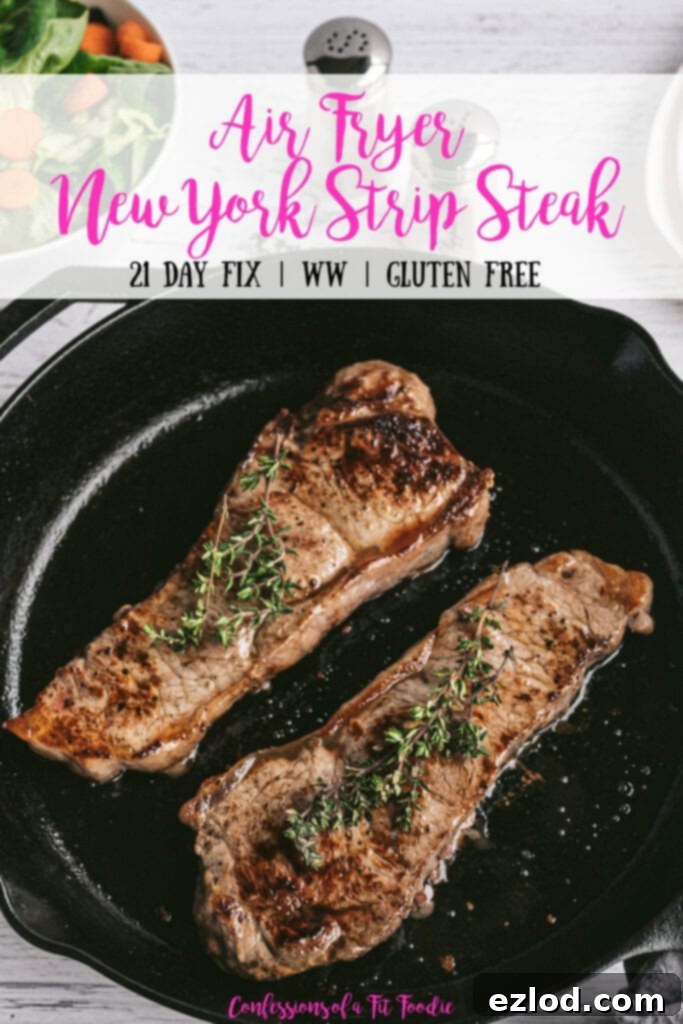 Overhead photo of Two New York Strip Steaks grilled in a Cast Iron Skillet with salt and pepper shakers and a salad in the background. With the text overlay- Air Fryer New York Strip Steak | 21 Day Fix | WW | Gluten Free | Confessions of a Fit Foodie