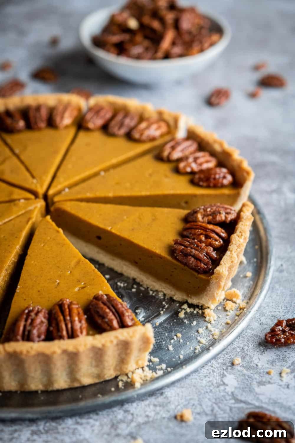 Side view of a beautifully baked vegan pumpkin pie, showcasing its golden crust and smooth filling.