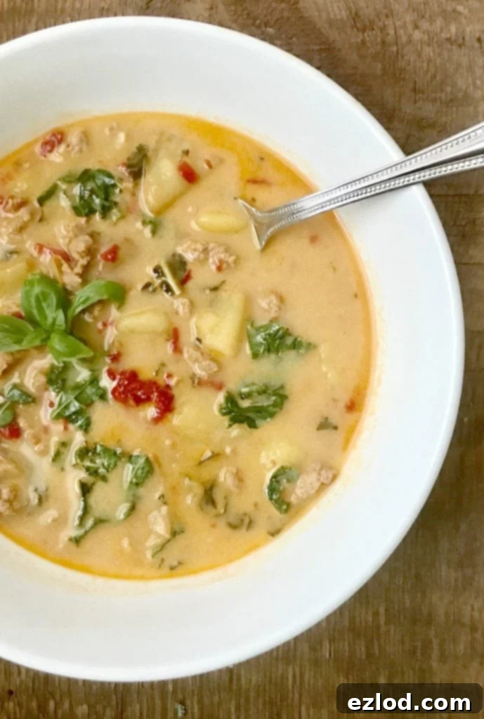 21 Day Fix Zuppa Toscana in a bowl, with sausage, potatoes, and kale, a hearty and healthy soup.