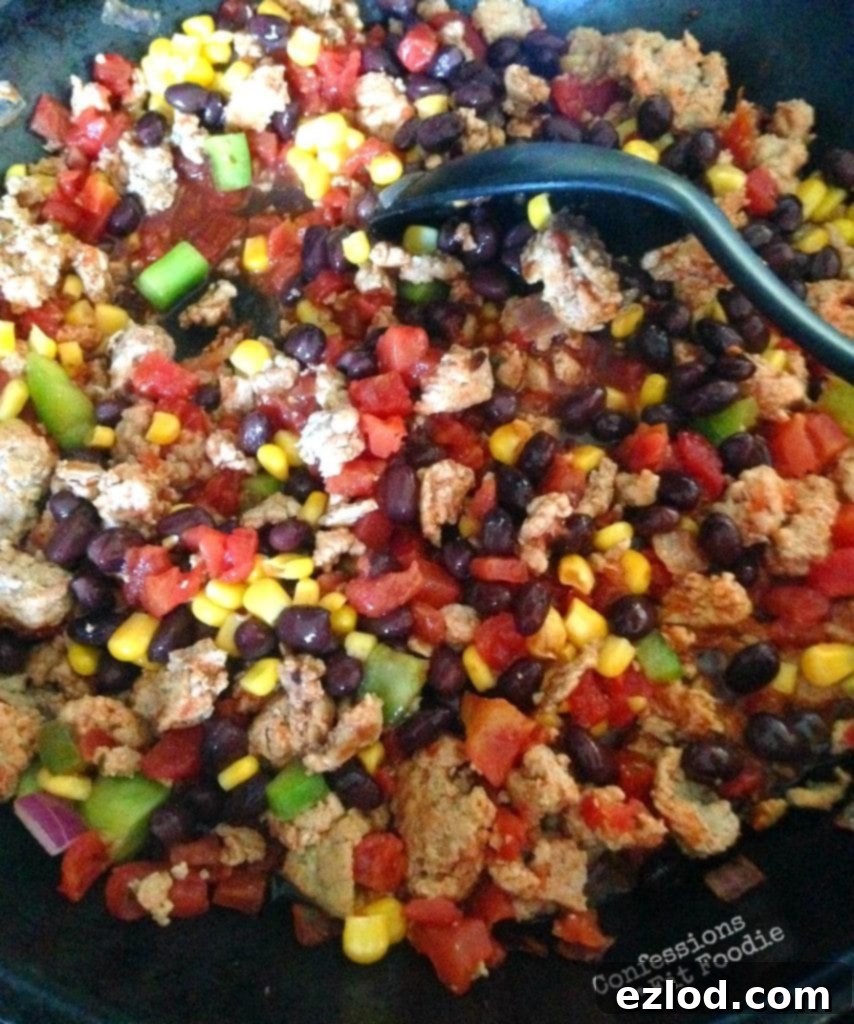 Turkey taco skillet with black beans, corn, and ground turkey, served in a cast iron pan.