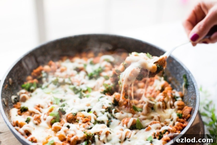 Healthy Sausage, Bean, and Kale Skillet in a pan, a quick and nutritious dinner.