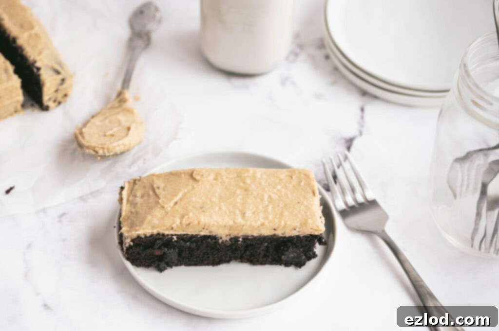 Slice of Gluten Free Chocolate Cake with Peanut Butter Frosting on a plate.