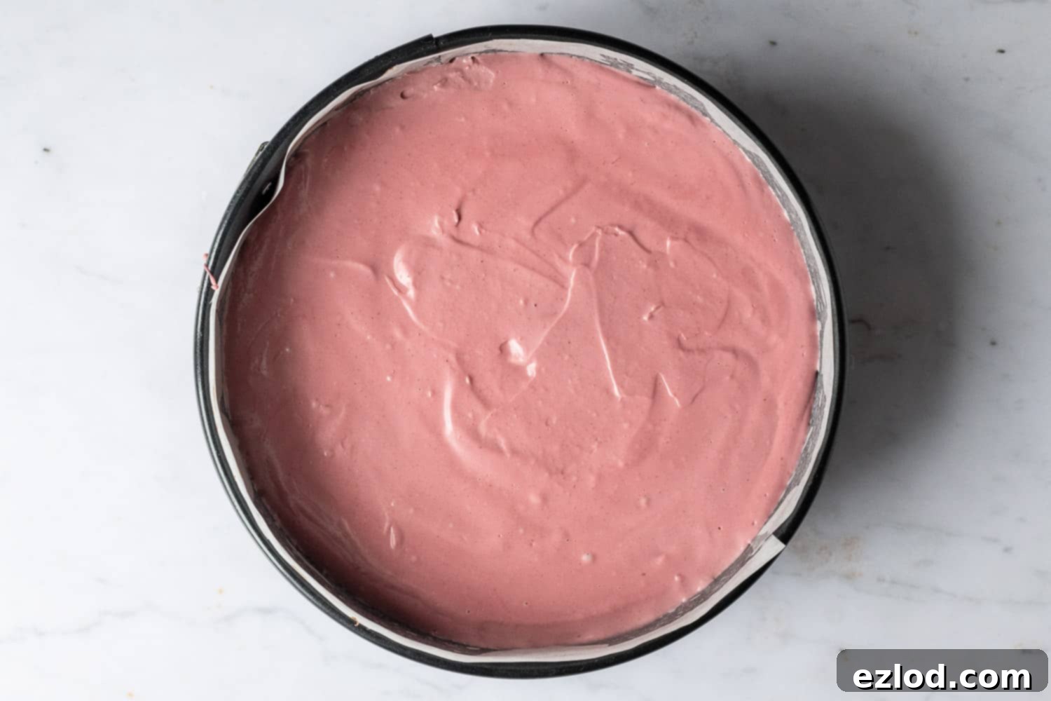 Step 6: The fully assembled no-bake vegan chocolate cherry cheesecake is in its springform pan, chilling in the refrigerator, ready to set.