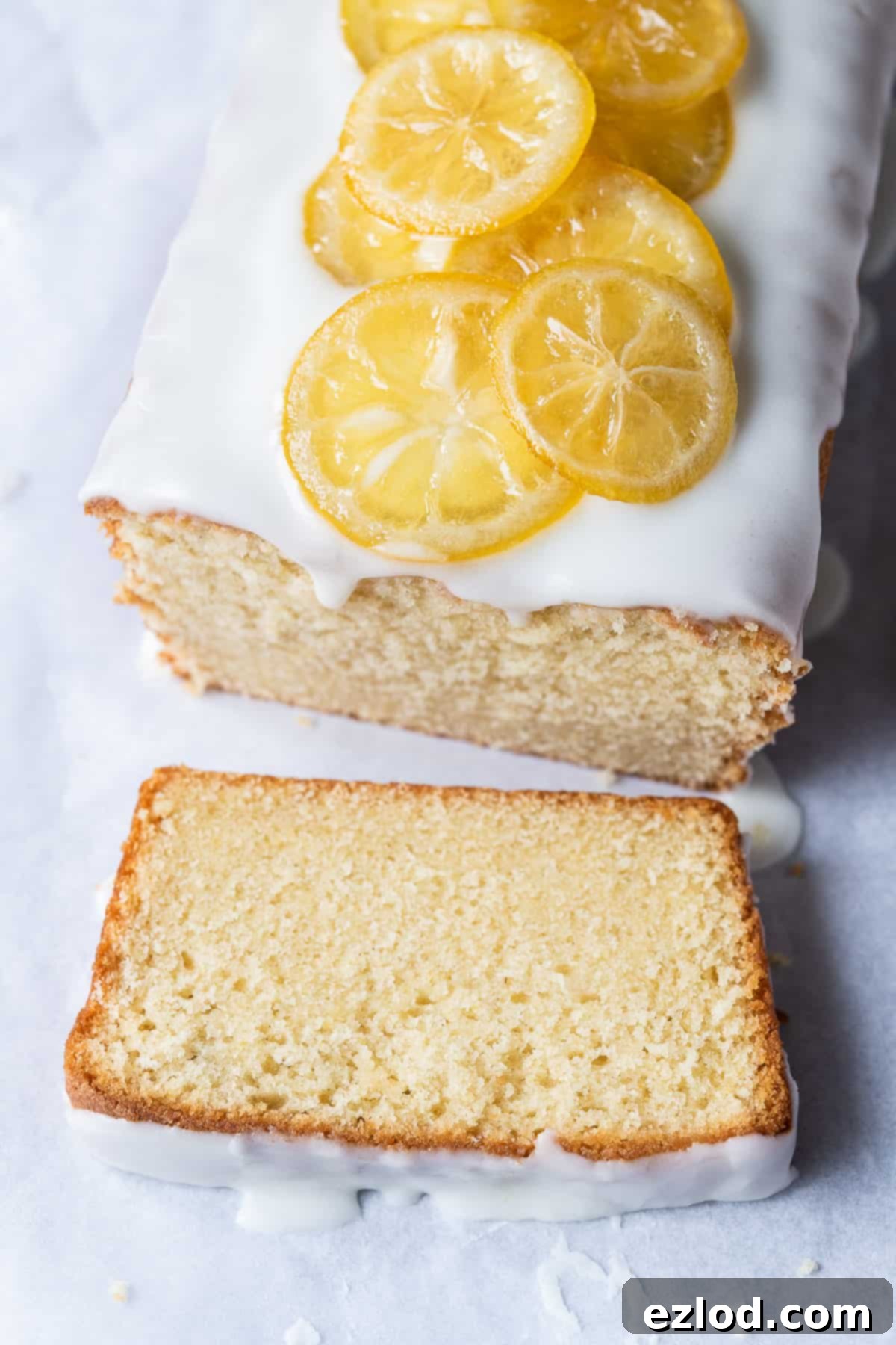 A close-up view of a perfectly baked slice of vegan lemon pound cake, showcasing its tender crumb and moist texture.