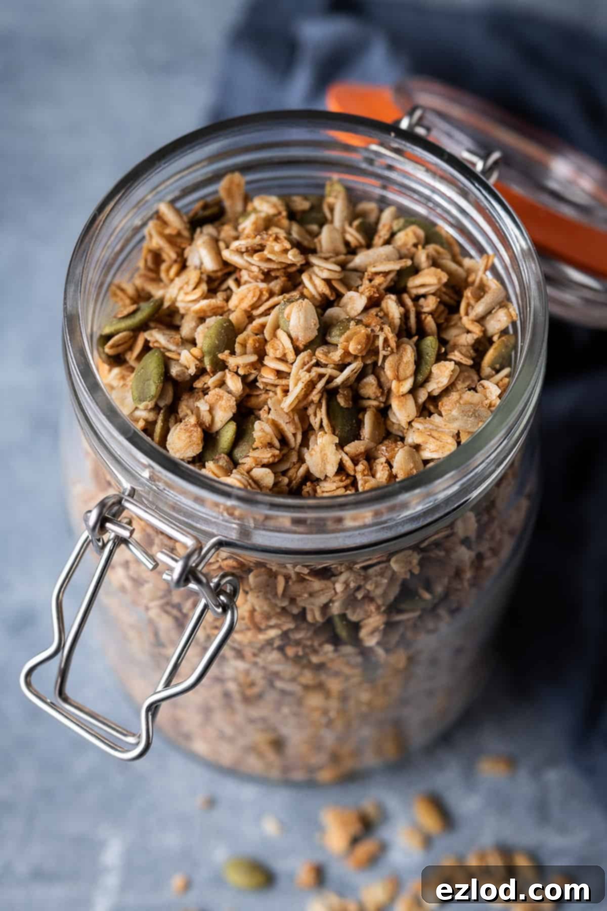 A glass jar filled with homemade vegan granola.