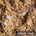 Close-up of a spoonful of golden vegan granola