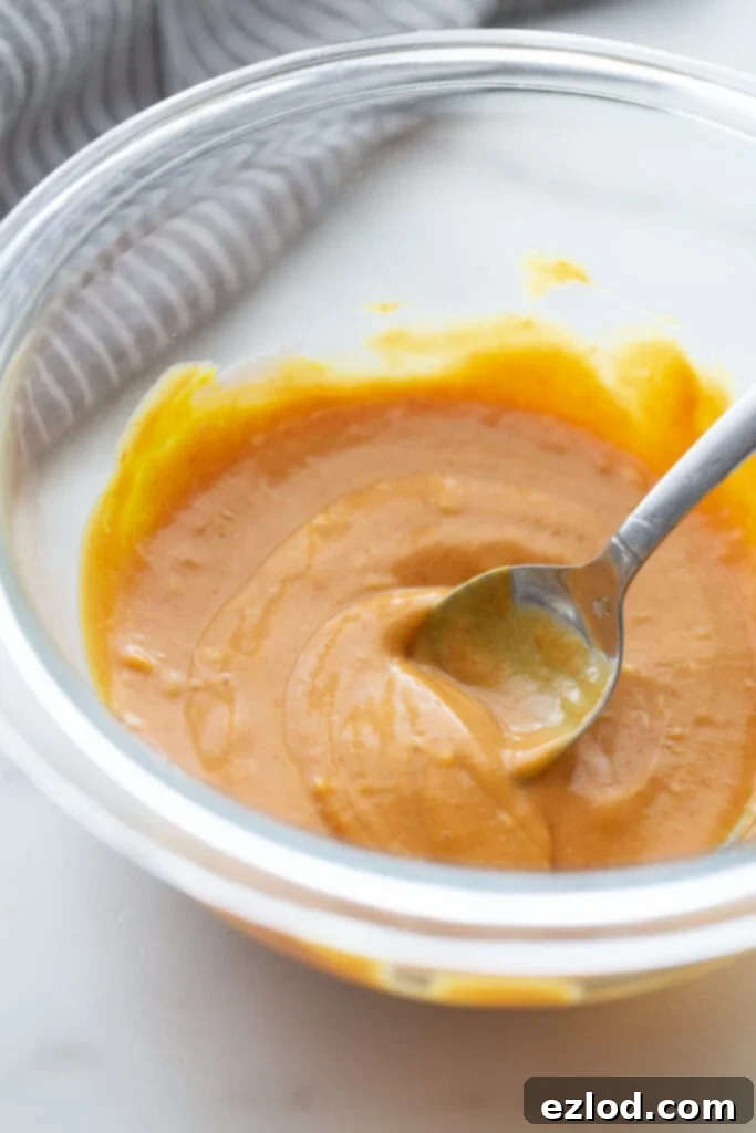Close up photo of the best burger sauce mixed with a spoon, in a glass bowl.