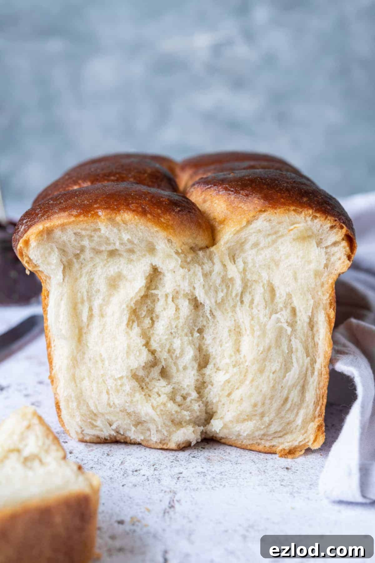 close up of the crumb of a loaf of vegan brioche with a piece torn off.