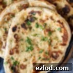 Vegan naan bread on a grey cloth.