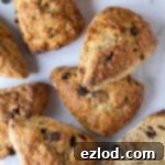 vegan banana scones on a marble surface, one sliced in half.