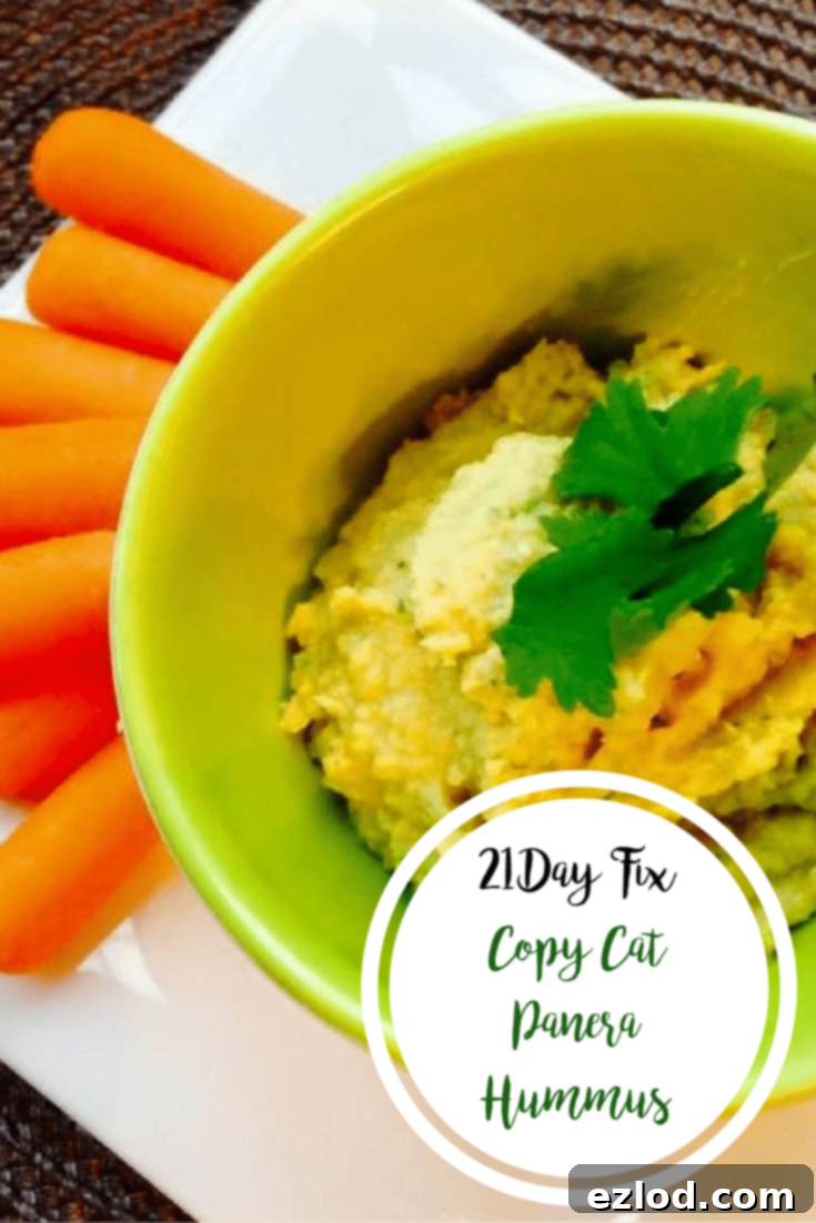Copy Cat Panera Hummus | Confessions of a Fit Foodie - A close-up of the smooth, creamy homemade hummus garnished with cilantro and sliced jalapeño.
