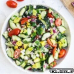 Fresh and vibrant Cucumber Tomato Avocado Feta Salad with honey lemon dressing.