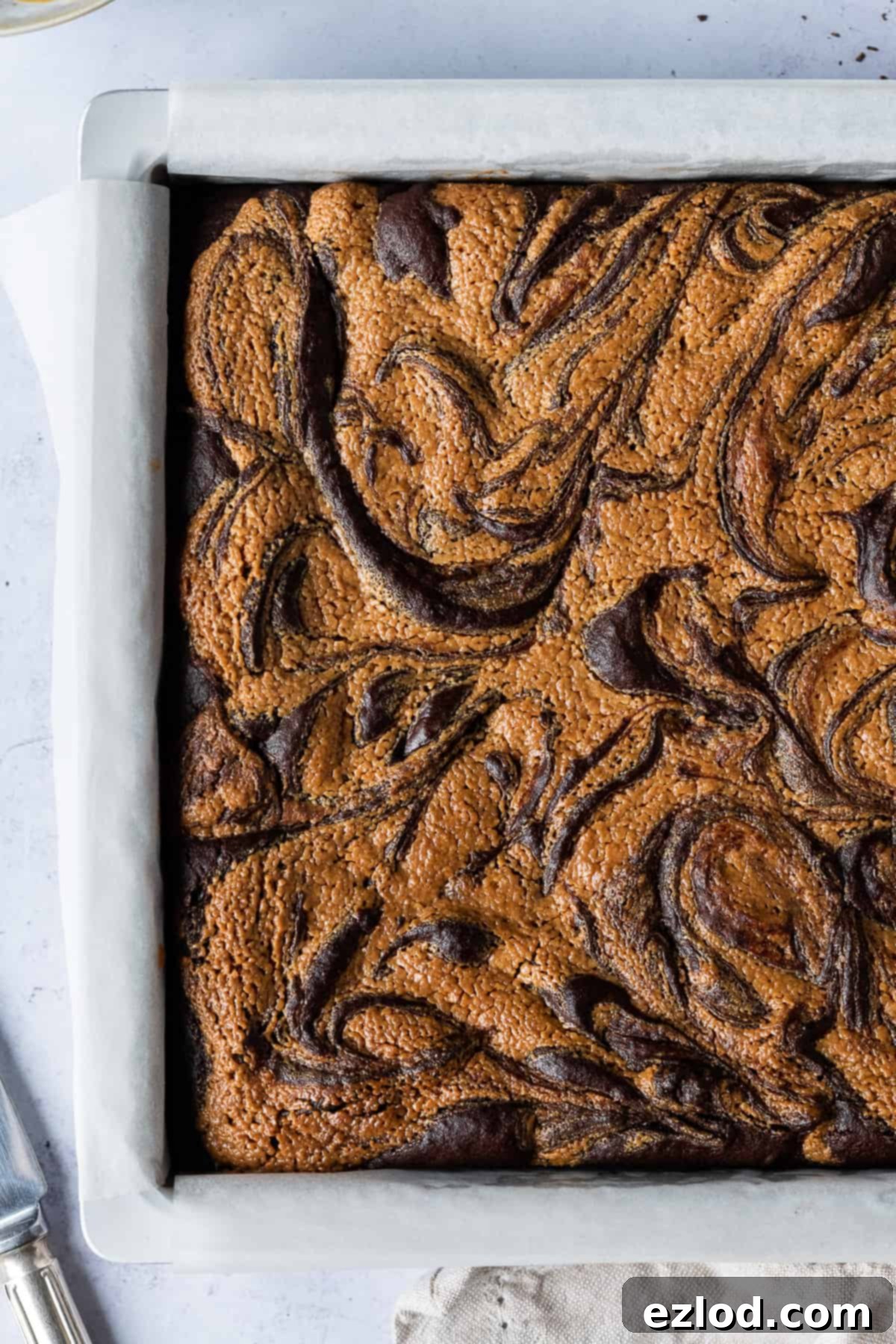 Peanut butter brownies in a metal cake tin.