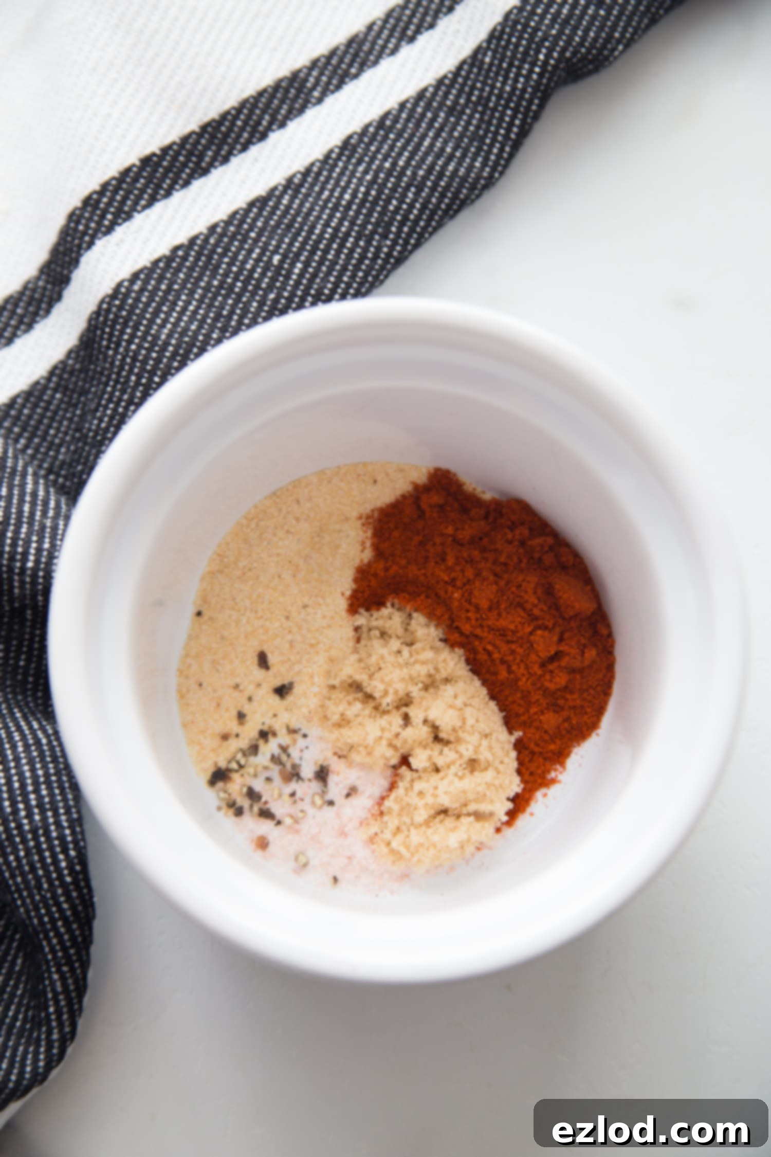 Effortless Crispy Chicken Thighs 4 A small white bowl with dry rub for chicken thighs.