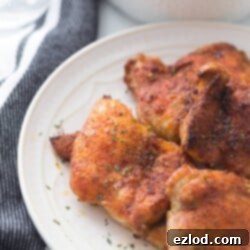 Effortless Crispy Chicken Thighs 7 overhead photo: crispy air fried chicken thighs on a white plate