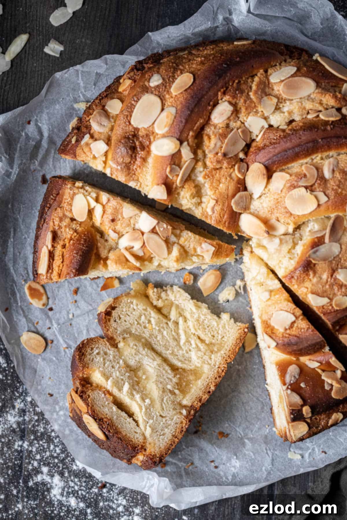 Close-up of a beautifully sliced vegan almond bread twist, showcasing its intricate spiral pattern and rich filling.