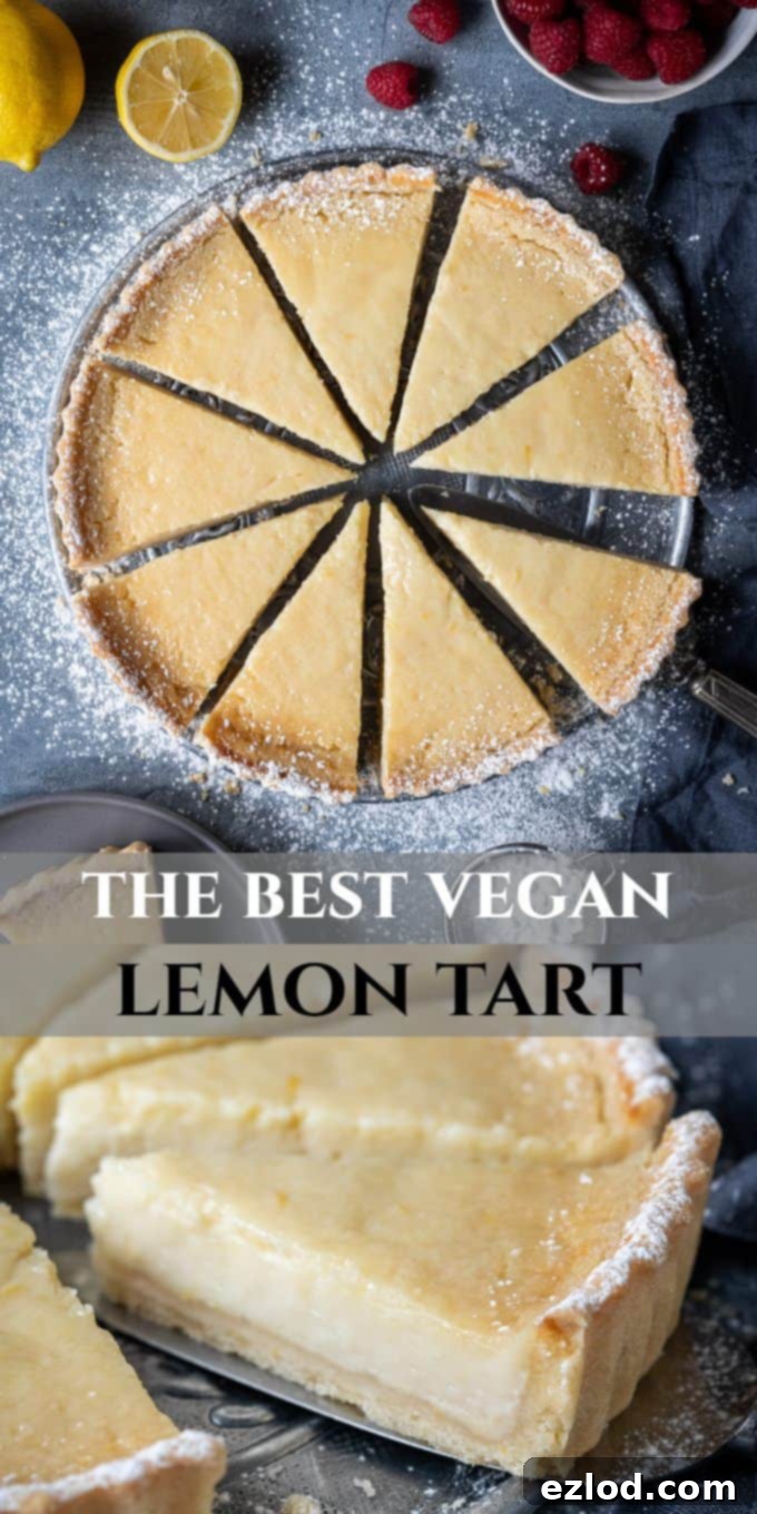 Pinterest image: A whole vegan lemon tart with slices, garnished with lemons and raspberries.