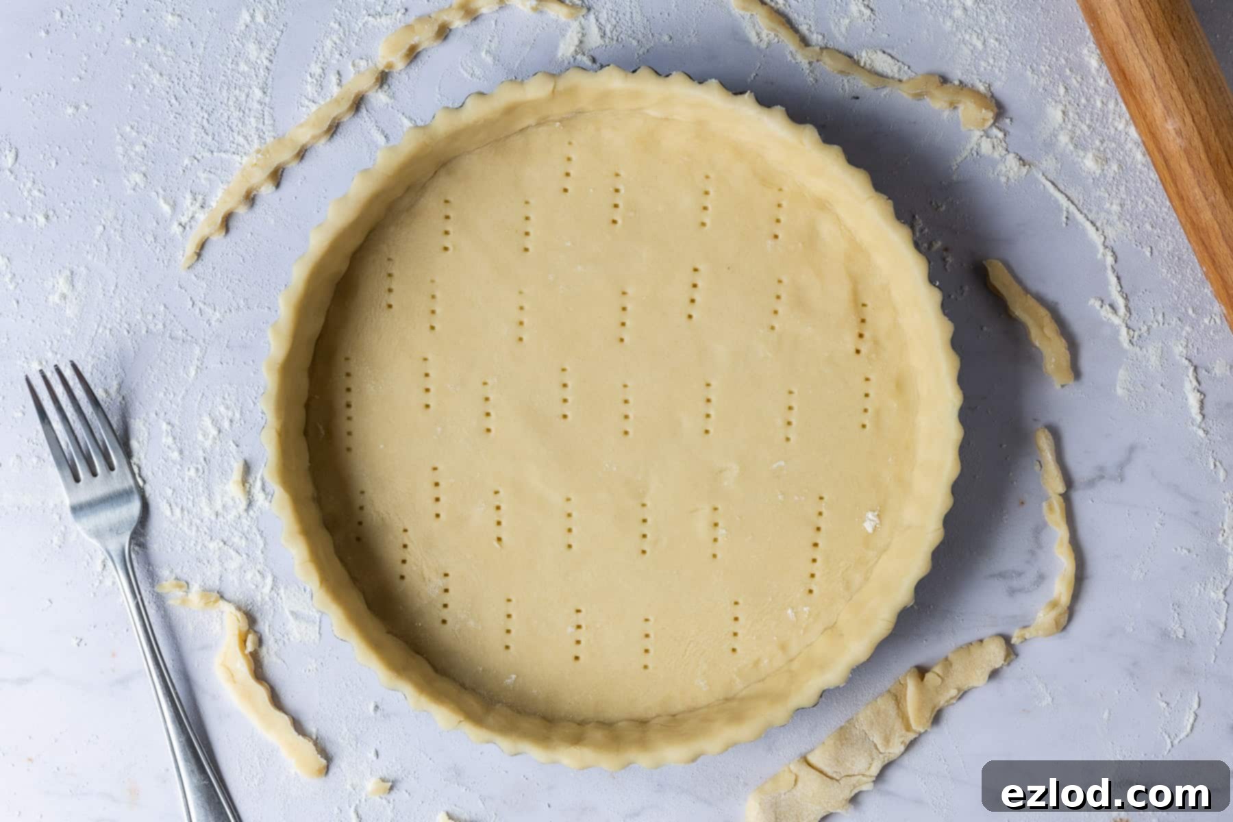 Step 2 in making vegan lemon tart: rolling out the pastry and lining a tart tin.