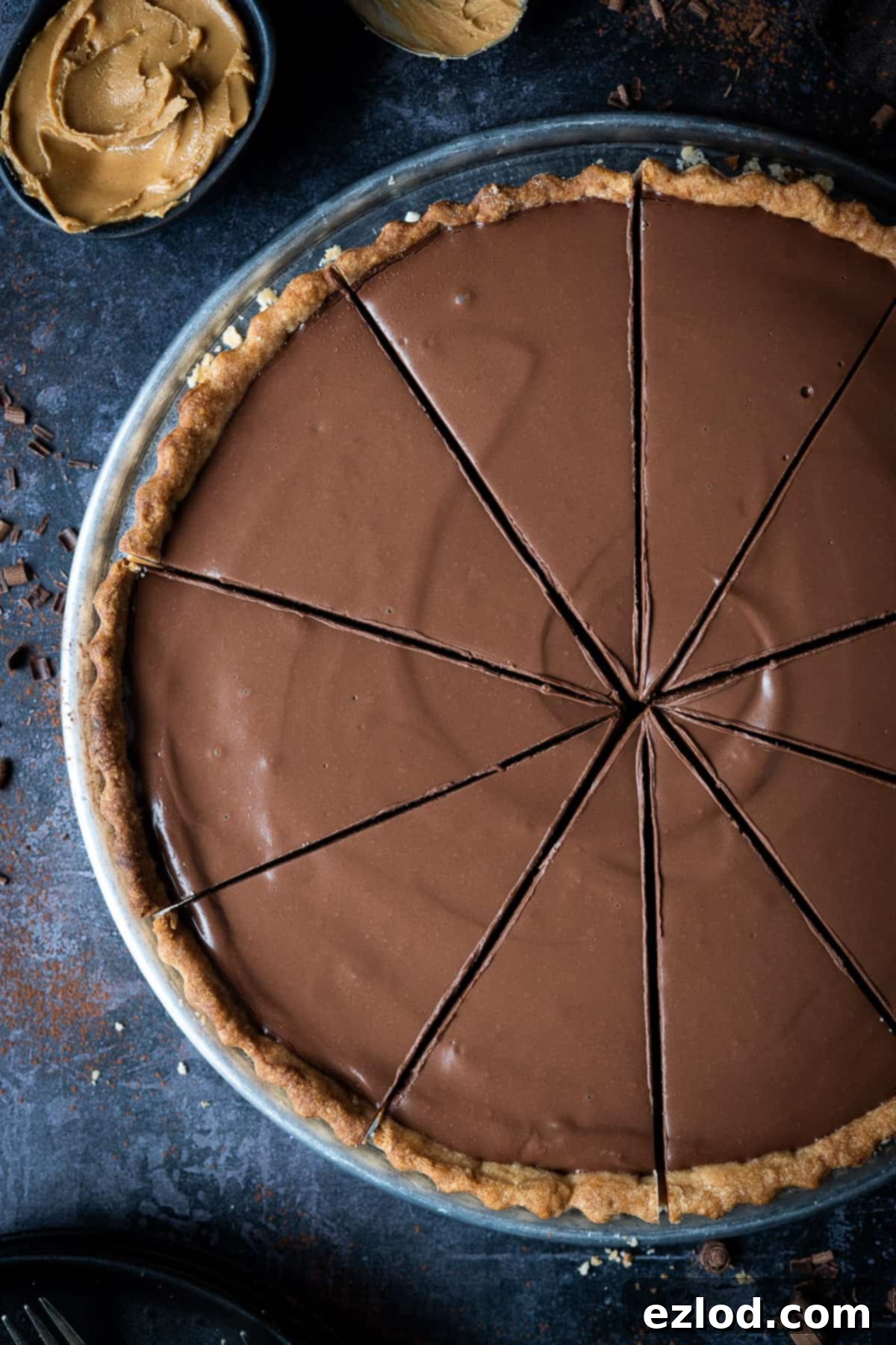 Several slices of vegan peanut butter chocolate tart arranged neatly, highlighting the smooth texture and rich color of the filling.