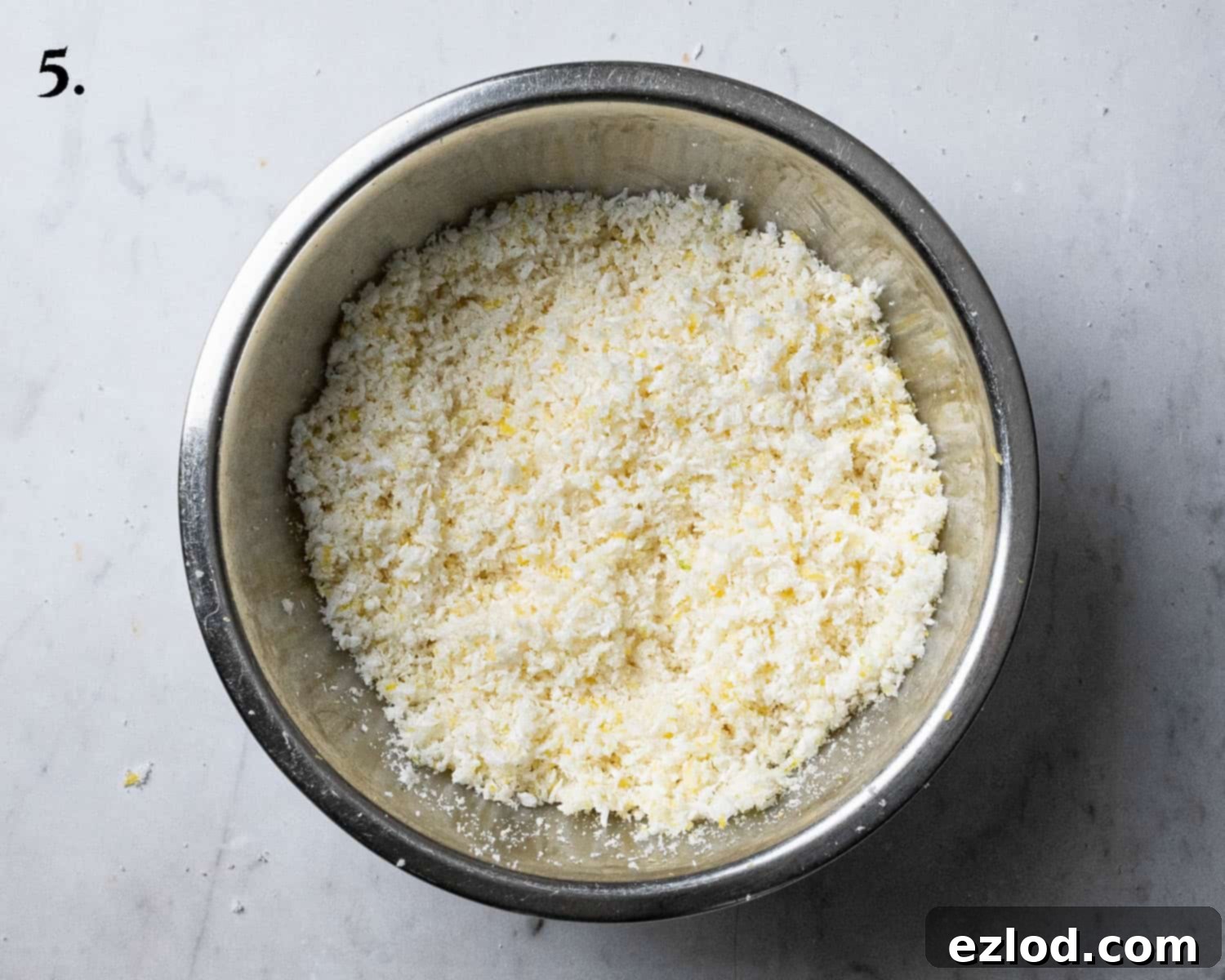 Step 5: The delicious lemon and coconut filling mixture prepared in a bowl, ready to be spread onto the dough.
