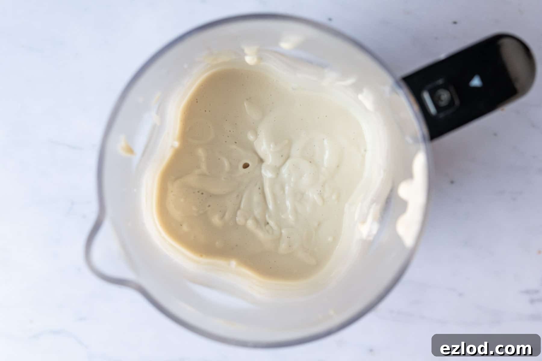 Step 4 in making vegan tiramisu: blending the cashew and silken tofu cream until smooth.