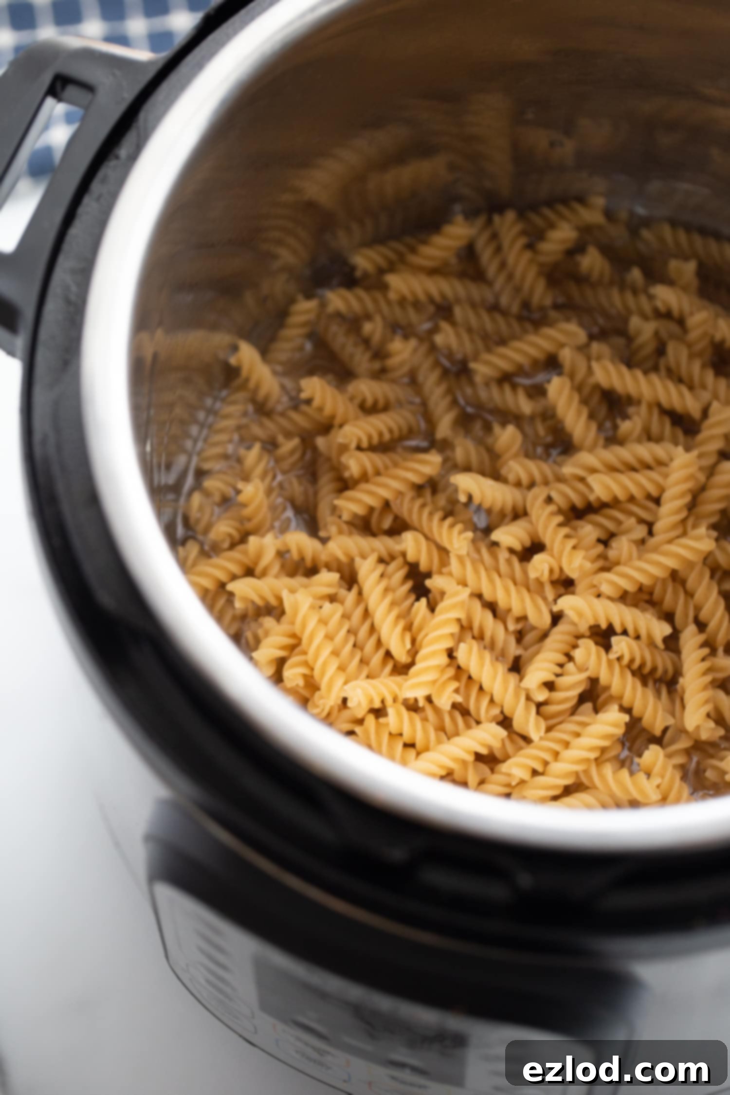 Overhead photo of raw rotini pasta in the instant pot