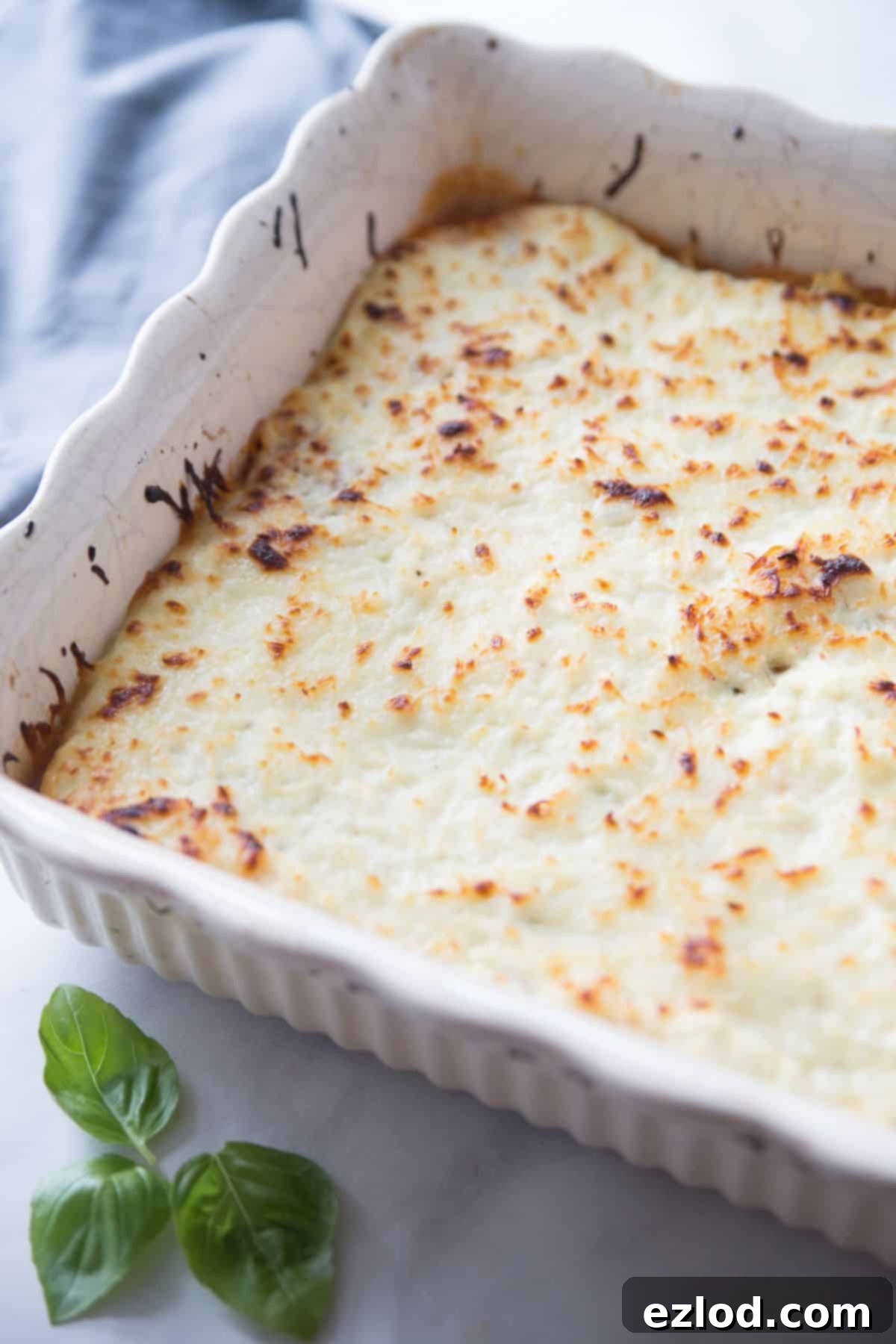 Low-Carb Spaghetti Squash Lasagna 6 Baked Spaghetti Squash Lasagna in a white ceramic baking dish.