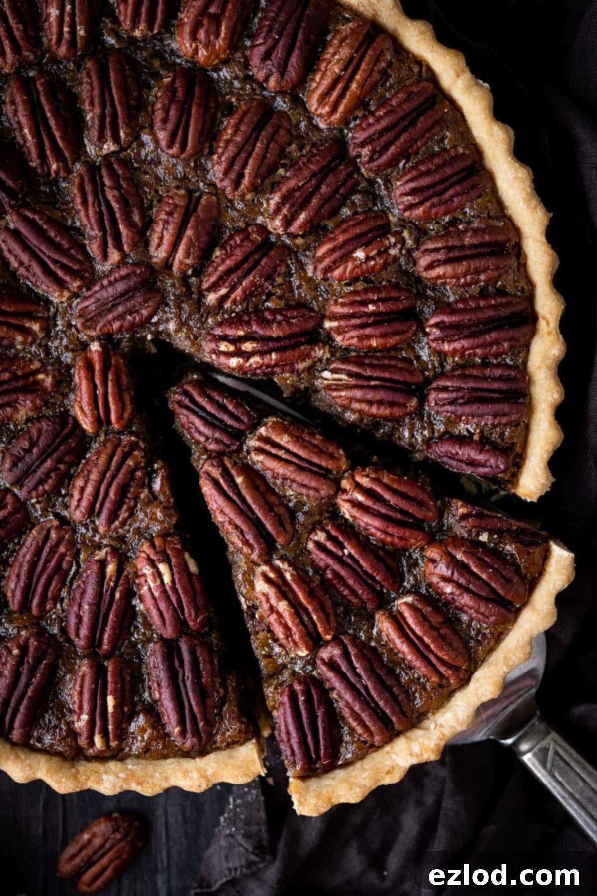 Close up of vegan pecan pie with a slice cut out.