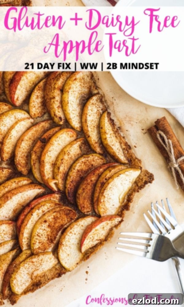 An overhead photo of a baking sheet completely filled with a golden, baked apple tart. The image features a white rectangle with bold black and pink text that reads: 'Gluten + Dairy Free Apple Tart | 21 Day Fix | WW | 2B Mindset | Confessions of a Fit Foodie', serving as an inviting visual summary of the recipe.