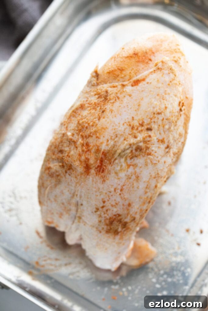 Seasoned turkey breast on a metal pan