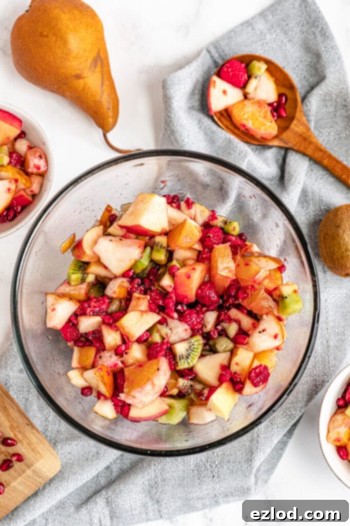 All fruits have been mixed together with a wooden spoon, creating a ready to serve winter fruit salad.