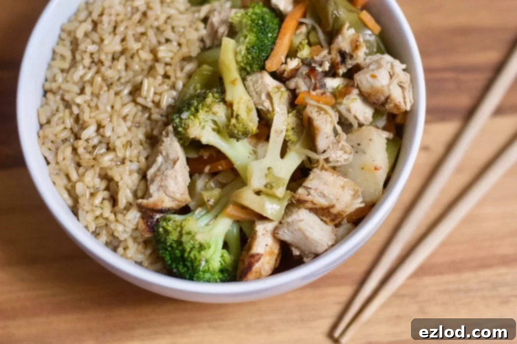 Prepared 21 Day Fix Chicken and Veggie Stir Fry in a pan with chopsticks