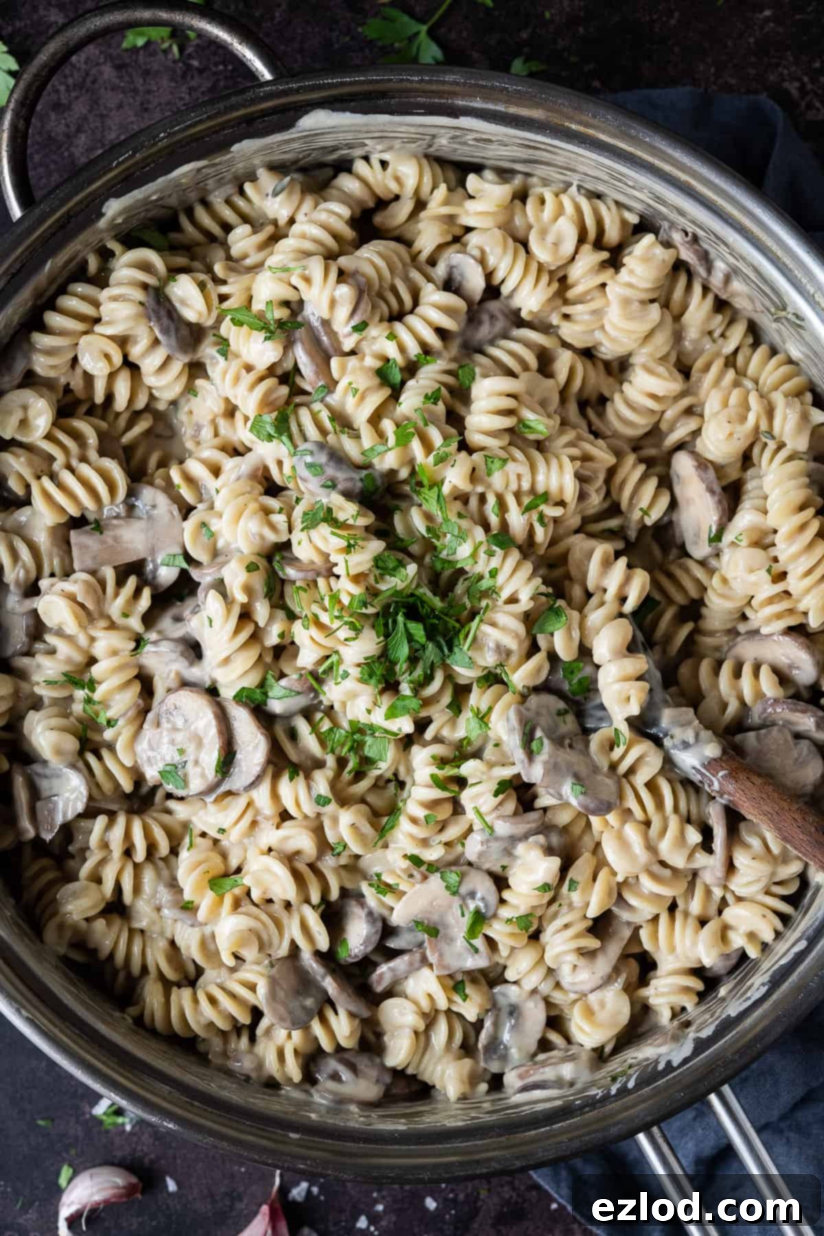 Close up of creamy vegan mushroom pasta topped with fresh parsley.